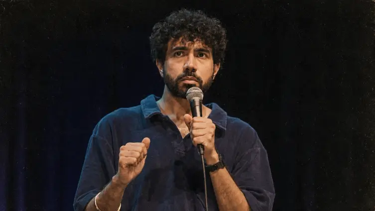 Creator performing on stage with a microphone