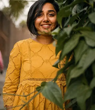 Lifestyle creator framed by greenery
