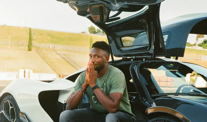 Auto creator beside a supercar